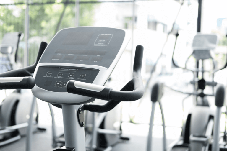 Elliptical machines in gym with fitness equipment
